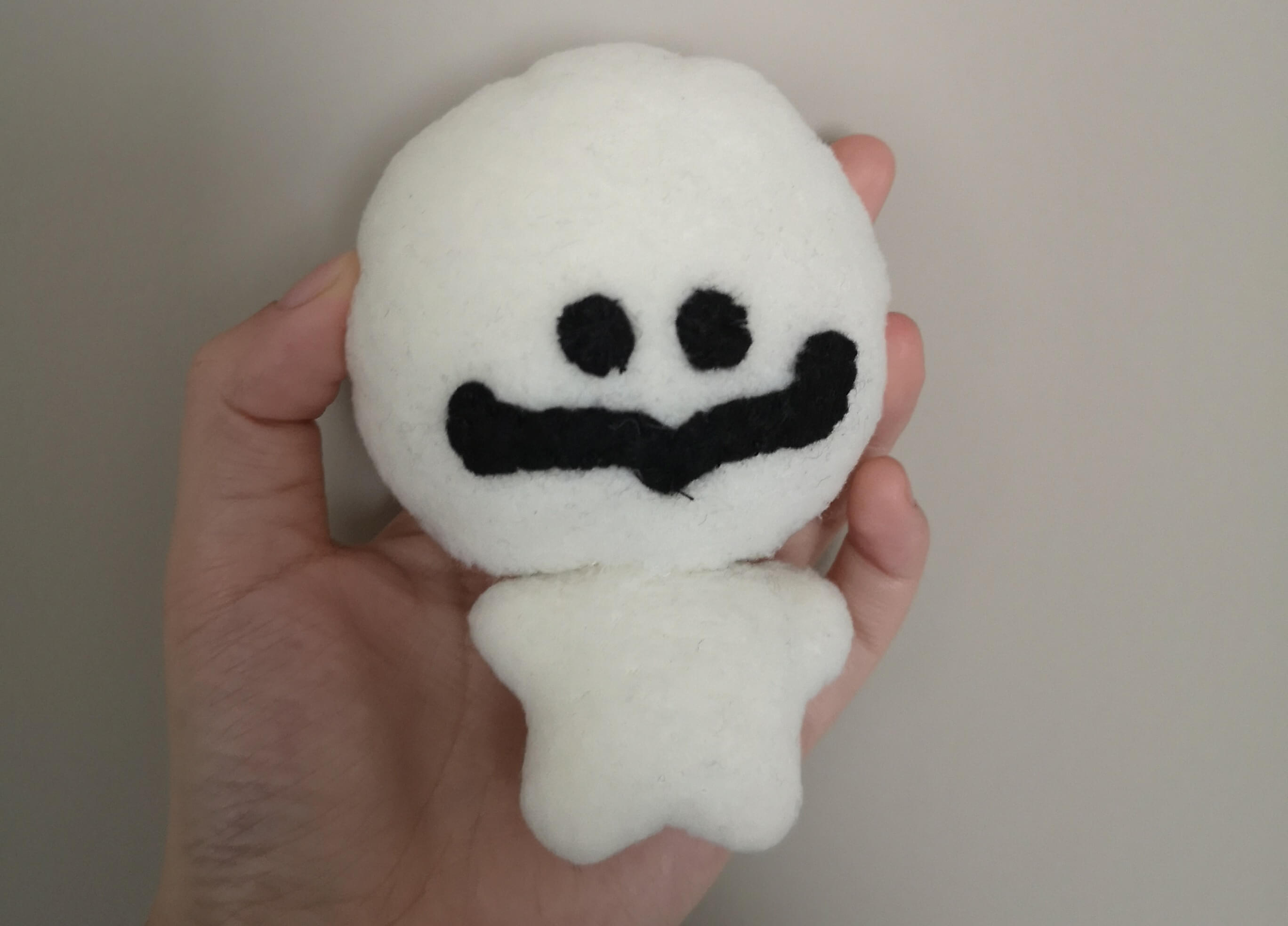plush of dipshit, a doughy white humanoid creature with a giant round head and tiny body